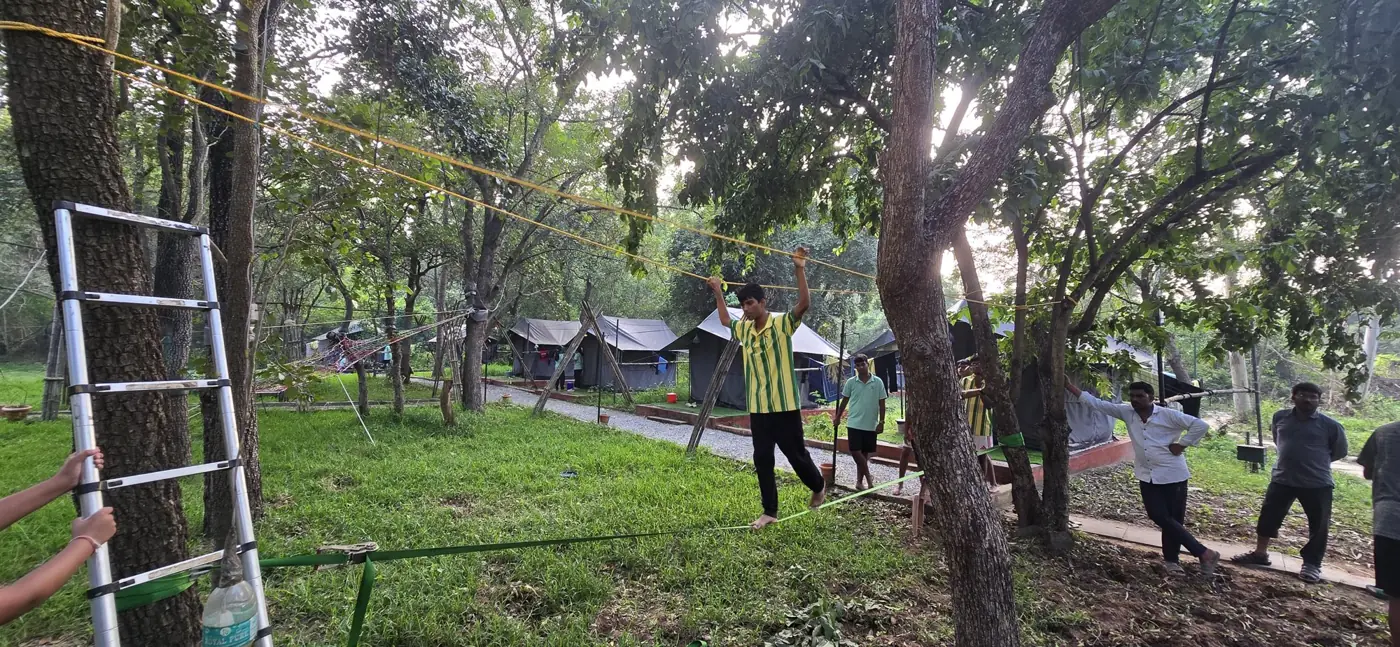 A student on a rope course between trees