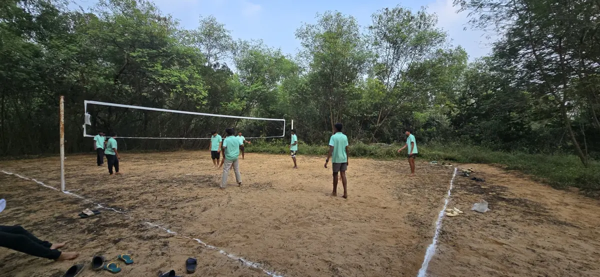 Students playing volleyball at the campsite
